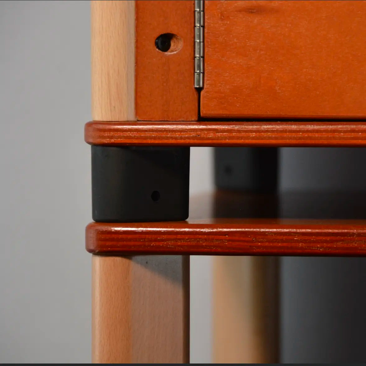 Close-up of a wooden hydroponic home farm with a hinge and black feet.
