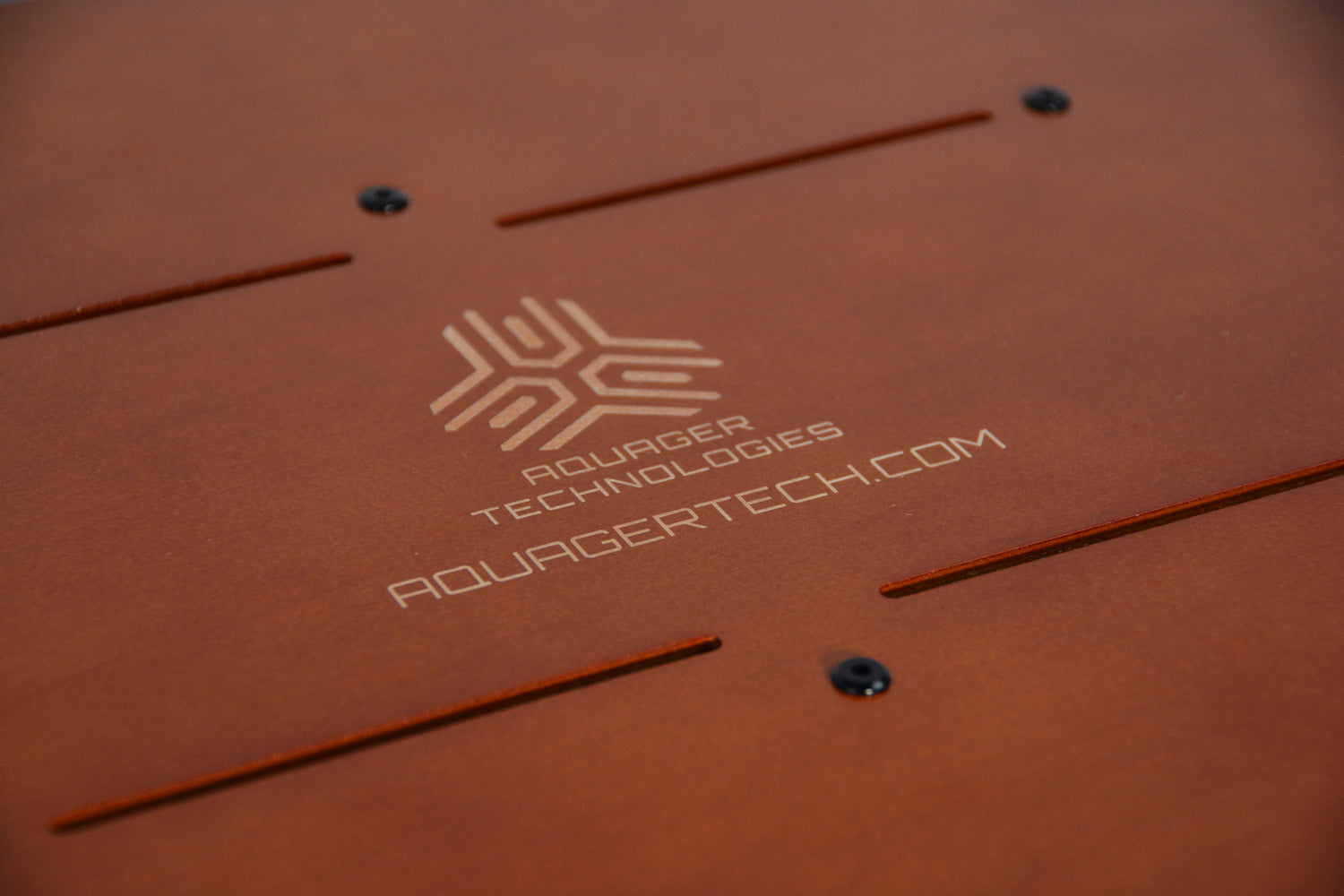 Laser-engraved Aquager Technologies logo on sustainable wooden hydroponic farm panel.