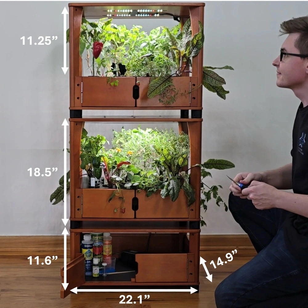 Stackable indoor gardening system with dimensions labeled, person sitting next to it.