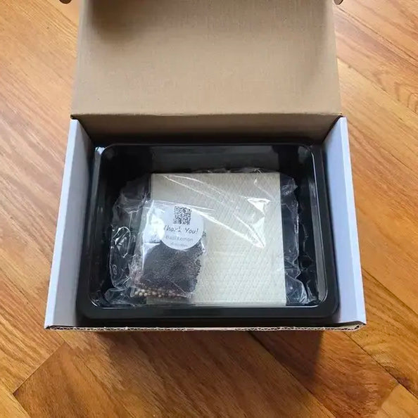 Microgreens kit inside the shipping box. Organic microgreens starter kit with humidity dome and seed varieties