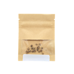 Sealed kraft paper seed packet with a clear window showing the seeds inside